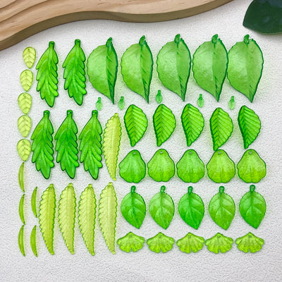 Clear leaf charms arranged on a light background