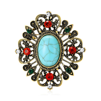 Ornate Oval Turquoise Color Crystal Brooch displayed from the front