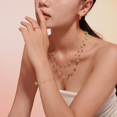 Model wearing layered green white stone chip necklace and matching bracelet