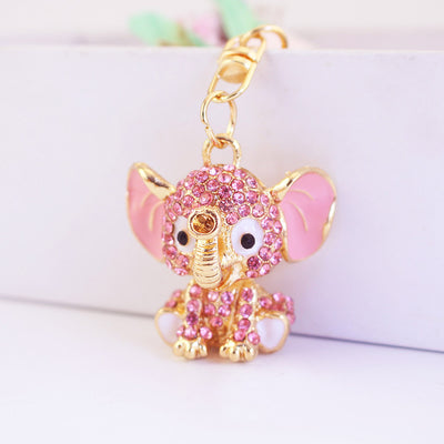 Close-up of a pink rhinestone elephant charm with a gold-tone clasp.