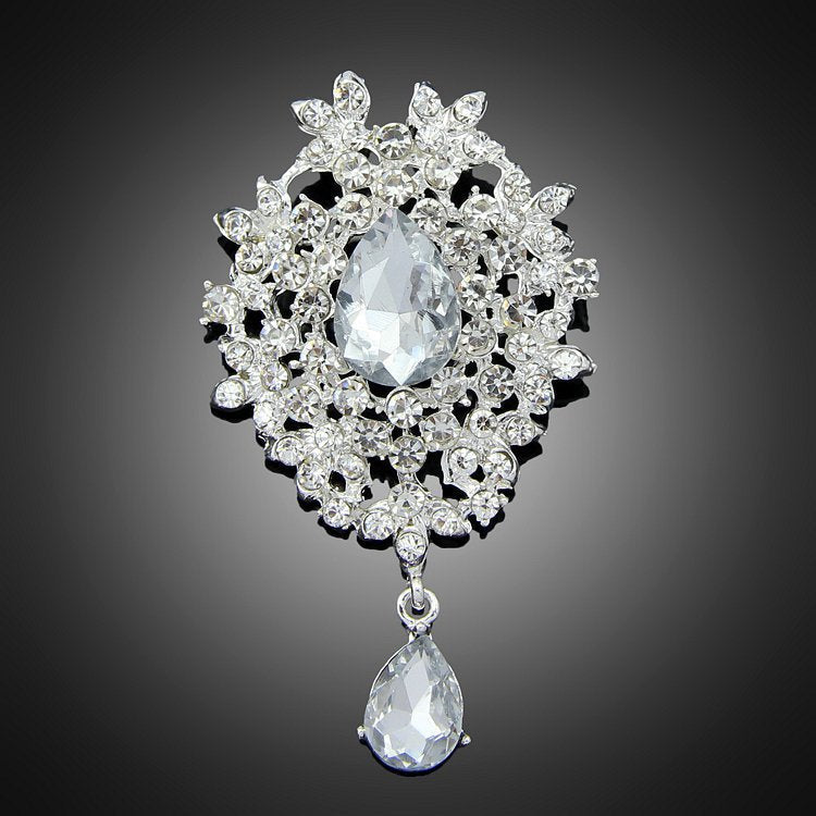 Silver-tone floral teardrop brooch with a dangling clear stone