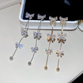 Gold Plated Copper Bow Tassel Drop Earrings With Silver Posts And Zircon Accents view 1
