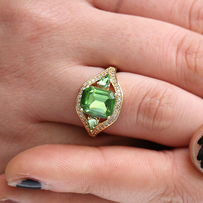 Gold Tone Green Emerald Cut Halo Ring In A Polished Decorative Design