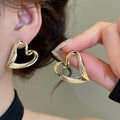 French Minimalist Hollow Heart Alloy Stud Earrings With Silver Pins Cool Luxury Style view 4