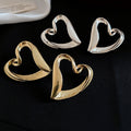 French Minimalist Hollow Heart Alloy Stud Earrings With Silver Pins Cool Luxury Style view 1