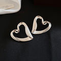 French Minimalist Hollow Heart Alloy Stud Earrings With Silver Pins Cool Luxury Style view 3