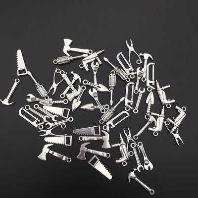 Metallic assorted shape charms shown in a close-up product view