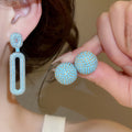 Light Luxury Copper Stud Earrings With Blue Zircon Oval Hollow Geometric Design view 2
