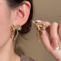 Light Luxury Gold Alloy Bowknot Stud Earrings, Elegant Niche Design Textured Ribbon Drop Fashion Earrings view 1