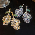 Light Luxury Copper Zircon Hollow Leaf Stud Earrings For Elegant Evening Wear view 2
