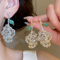 Light Luxury Copper Zircon Hollow Leaf Stud Earrings For Elegant Evening Wear view 1