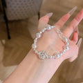 French Style Rhinestone Camellia Faux Pearl Bangle Elegant Light Luxury Floral Bracelet For Women view 1