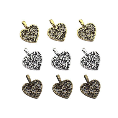 Antique silver heart charms arranged on a light background