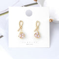 Gold Wire Wrapped Pink Pearl Look Small Huggie Earrings view 2
