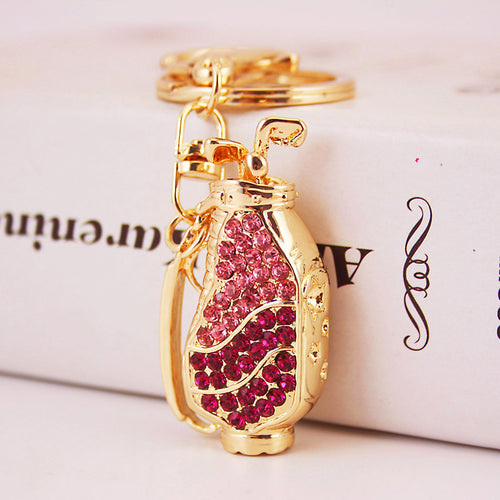 Close-up of a pink and deep pink rhinestone golf bag charm attached to a split ring.