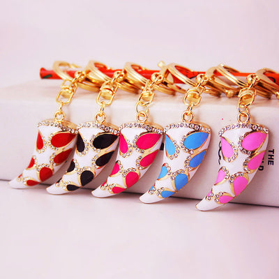 Five curved horn keychains in red, black, rose red, blue, and pink arranged together.