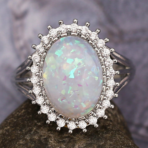 Second product view showing silver-tone opalescent oval cabochon halo ring
