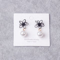 Black Outline Flower and White Pearl Look Drop Earrings view 2