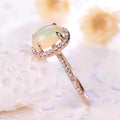 Rose Gold Tone Oval Opalescent Halo Ring In A Polished Decorative Design view 3