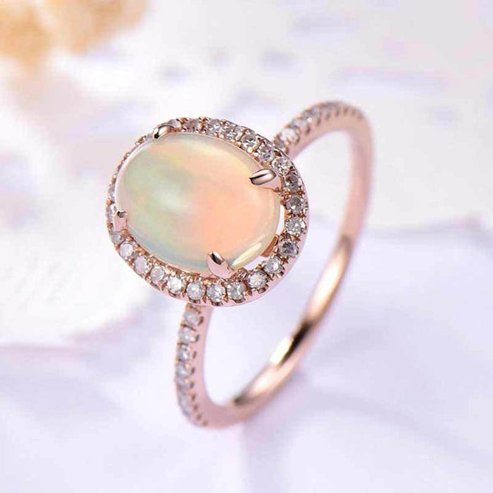 Rose Gold Tone Oval Opalescent Halo Ring In A Polished Decorative Design
