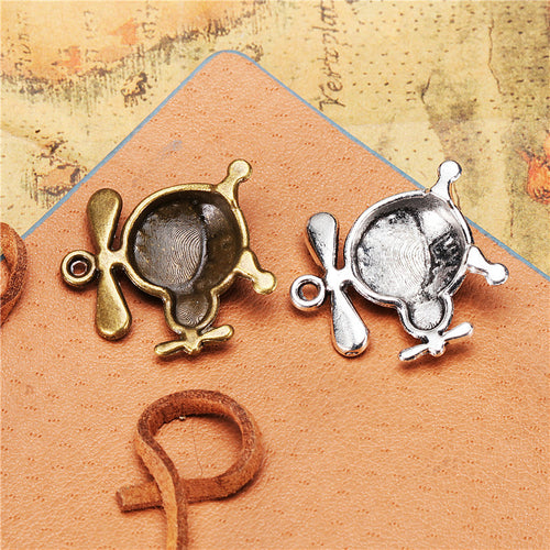 Alternate product view of the round helicopter charm showing its shape and edges.