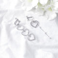 Clear Look Triple Heart Asymmetric Clip Earrings in Two Finishes view 2