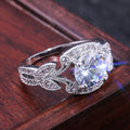 Silver Round Stone Leaf Halo Ring In A Polished Decorative Design view 3