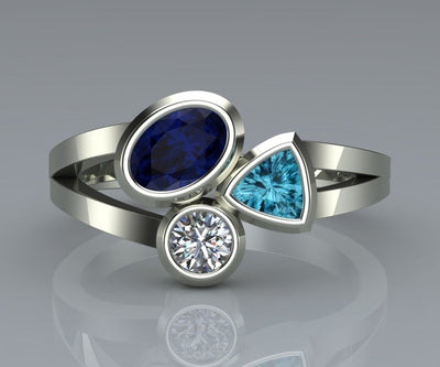 Studio render of silver three-stone ring with blue oval aqua triangle clear round
