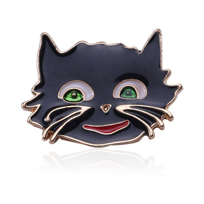 Front view of smiling black cat face with green eyes and raised whiskers