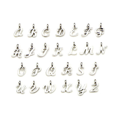 Metallic alphabet letter charms arranged on a light background