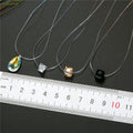 Iridescent Faceted Teardrop Crystal Pendant on Invisible Cord Necklace view 4