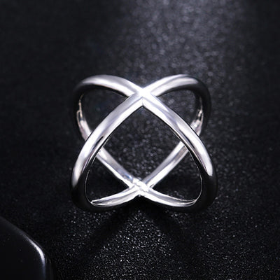 Front product view of silver tone sculptural crossing open ring
