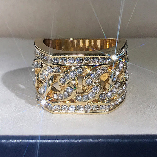 Side detail view of gold tone wide geometric statement ring with clear stones