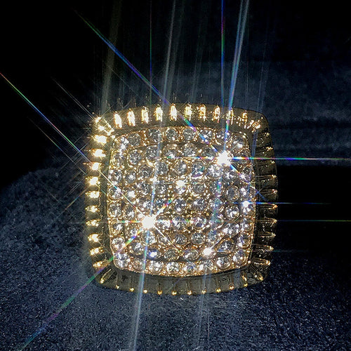 Side detail view of gold tone square pave statement ring with clear stones