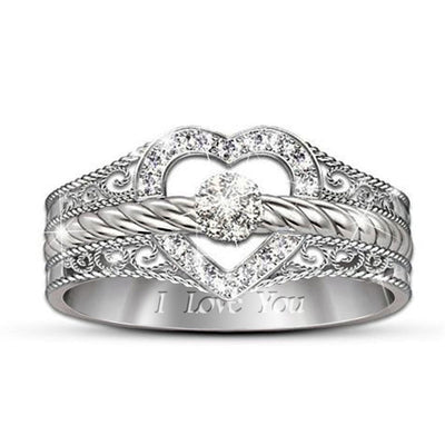 Front product view of silver tone filigree heart ring with clear stone bands