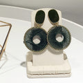 Woven Circle Drop Earrings with Sculpted Polished Metal Details view 2