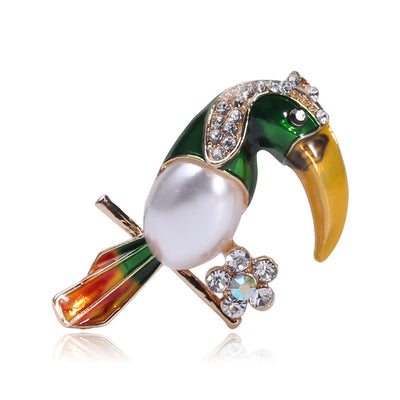 Green enamel pearl toucan brooch with yellow beak and crystal flower