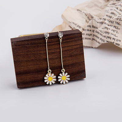Primary supplied view of gold bar white daisy dangle earrings