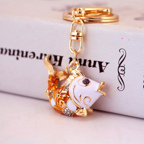 Close-up of an orange and white koi fish keychain with clear rhinestone accents.