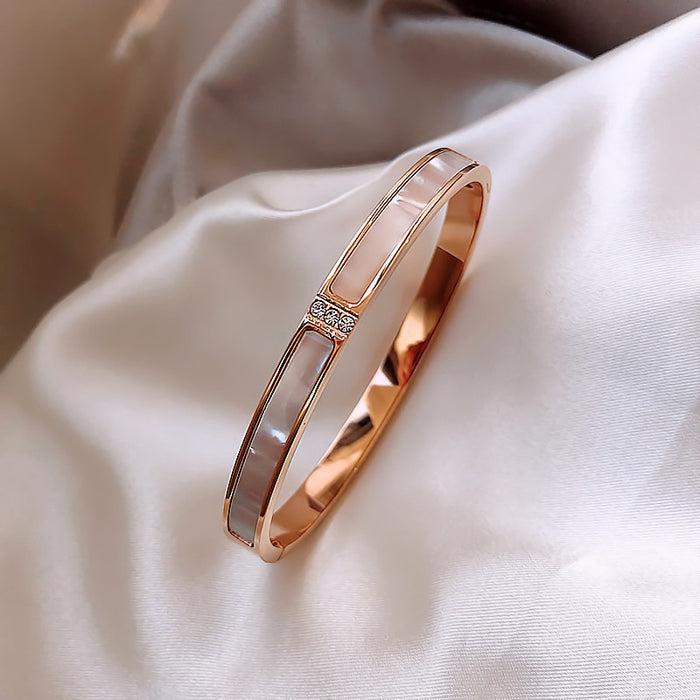 Four Gold Tone Bangle Styles With Shell Inlay And Crystal Details