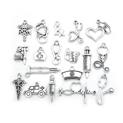 Silver-tone assorted shape charms arranged on a light background