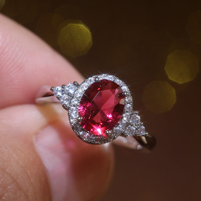 Red Oval Halo Three-Stone Ring In Polished Silver Tone