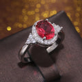 Red Oval Halo Three-Stone Ring In Polished Silver Tone view 3