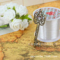 Floral Scroll Key Metal Charm in Three Vintage Finishes view 4