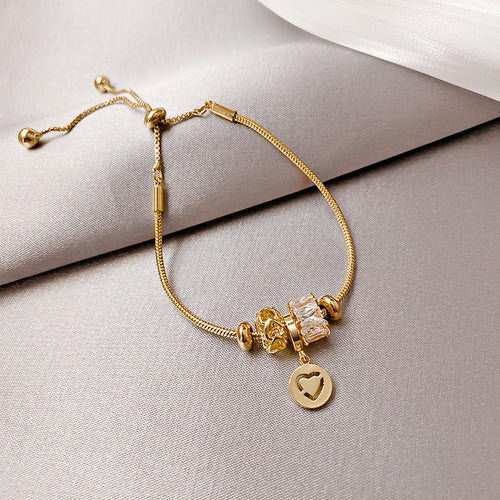 slider bracelet with crystal beads and a cutout heart charm in a close product photo