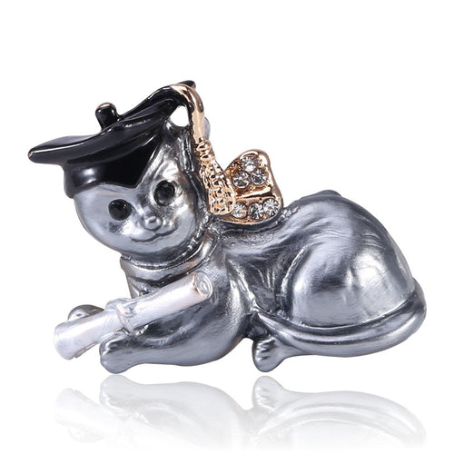 Front view of lying dog wearing a graduation cap and a crystal-set bow