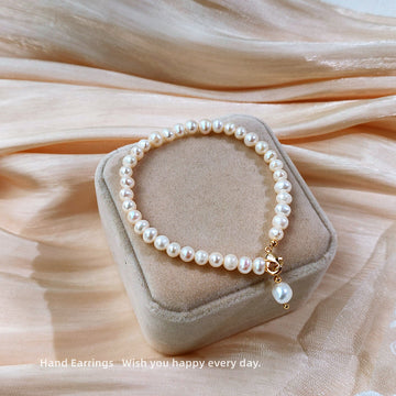 White Pearl Like Strand Bracelet With Single Drop Accent