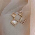 Geometric Cat Eye Earring Collection with Sculpted Polished Metal Details view 3