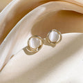 Geometric Cat Eye Earring Collection with Sculpted Polished Metal Details view 11