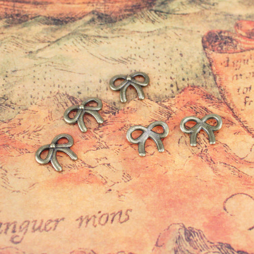 Alternate view of the tiny bow embellishment showing its raised and recessed details